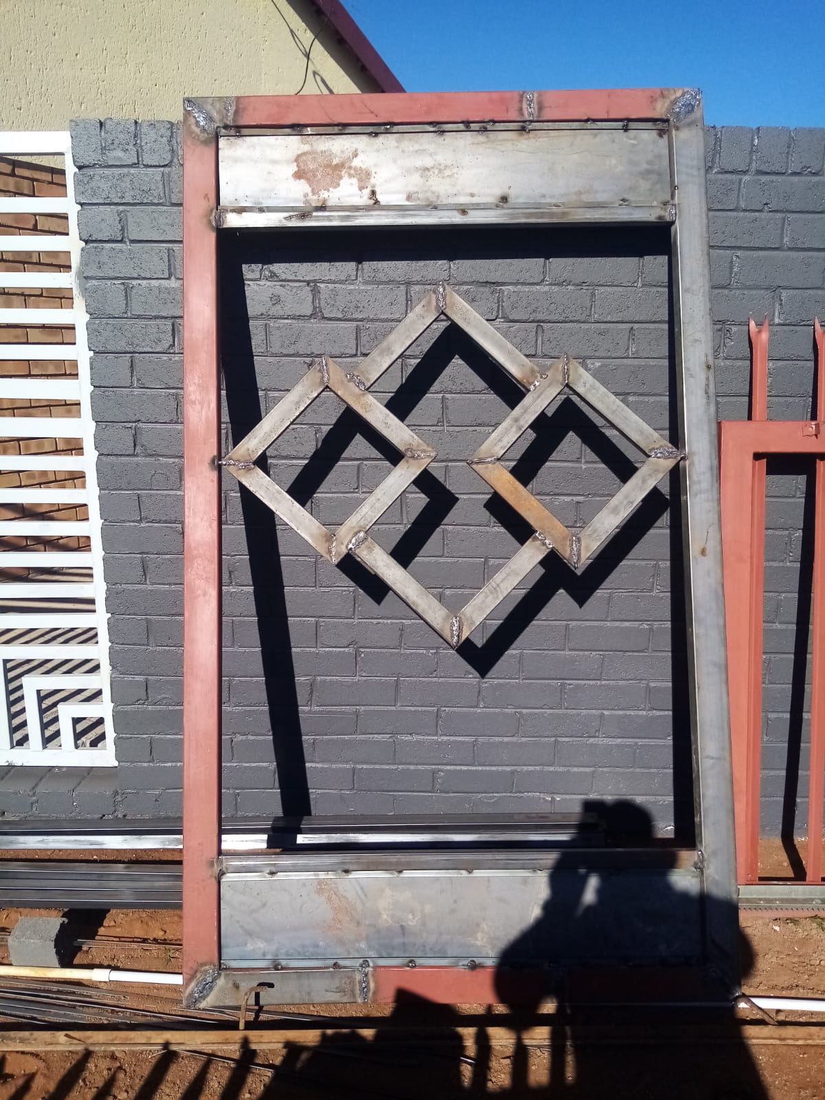 Charcoal steel gate with a diamond feature panel