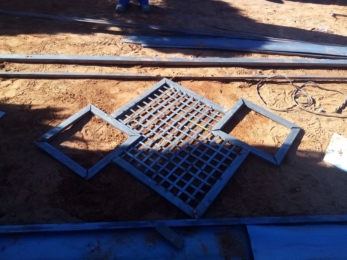 Steel gate panels laid out under fabrication on site