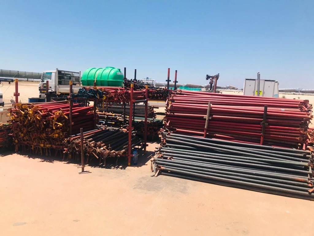 Stacked palisade fencing and steel stock in the Bold T yard